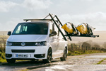 Droprack laden with kayaks lowered from a Volkswagen Transporter