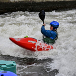 A freestyle kayaker wearing the Sweet Rocker Helmet at Nottingham